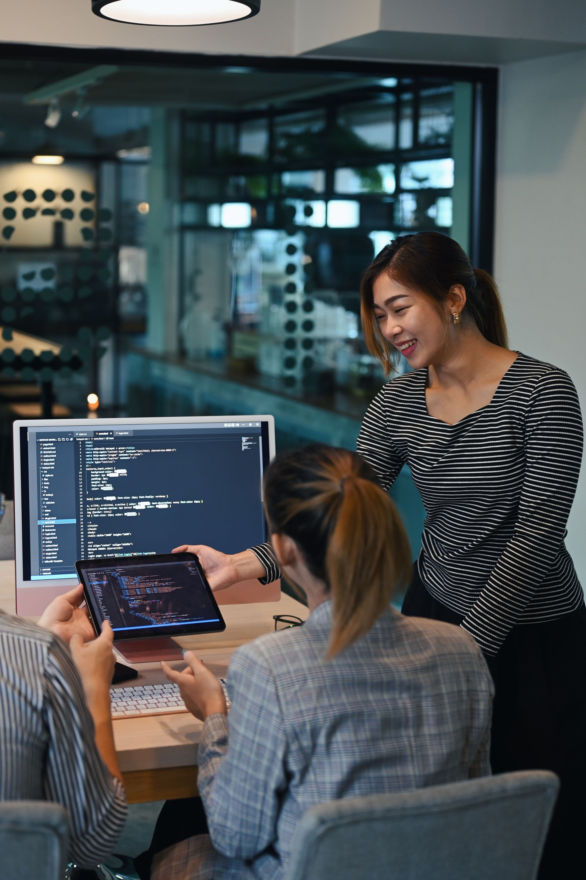 AI enhanced website design and coding technologies at a creative office.